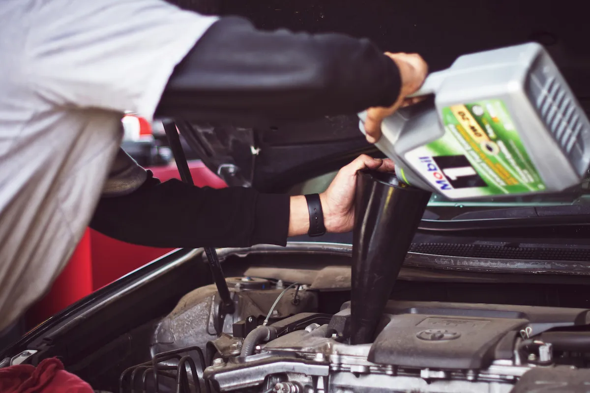 Technician performing routine vehicle maintenance