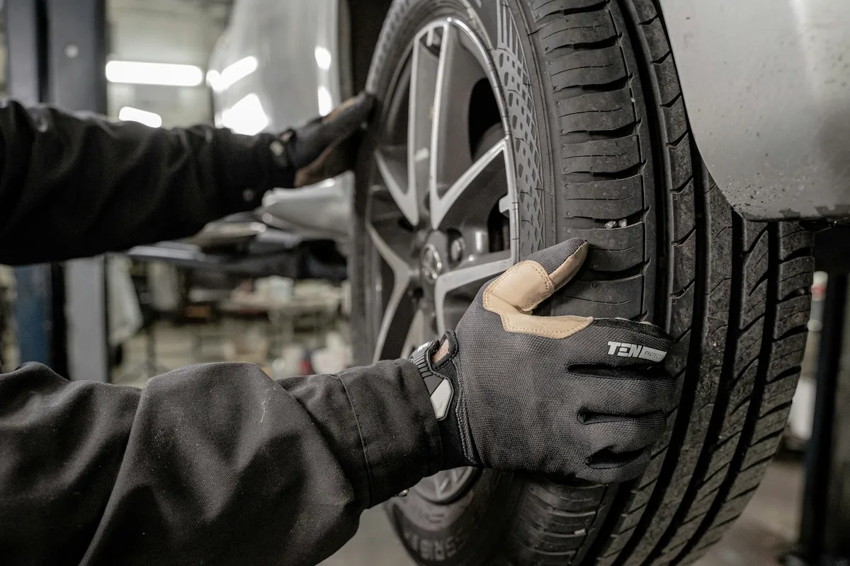Technician servicing a vehicle tire